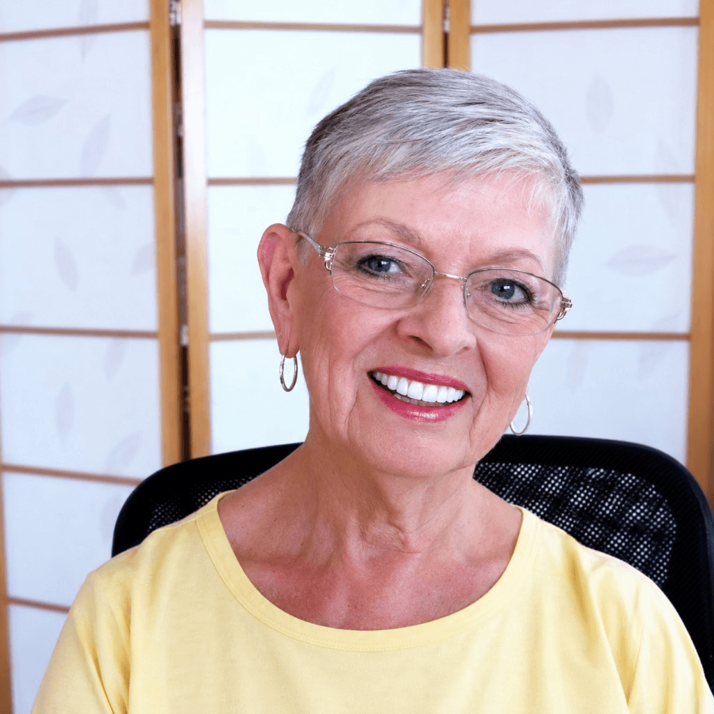 Betty Lue seated at her desk
